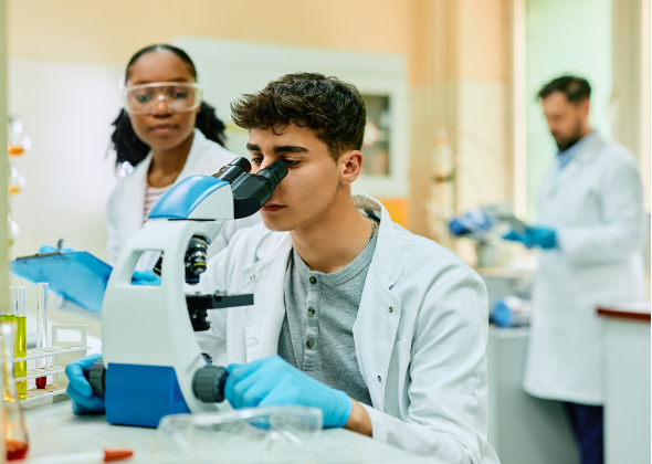 Scientists observe lab samples with a microscope